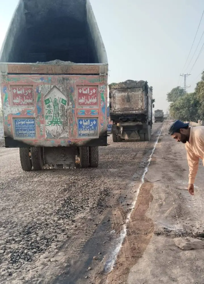 Trucks supplying asphalt